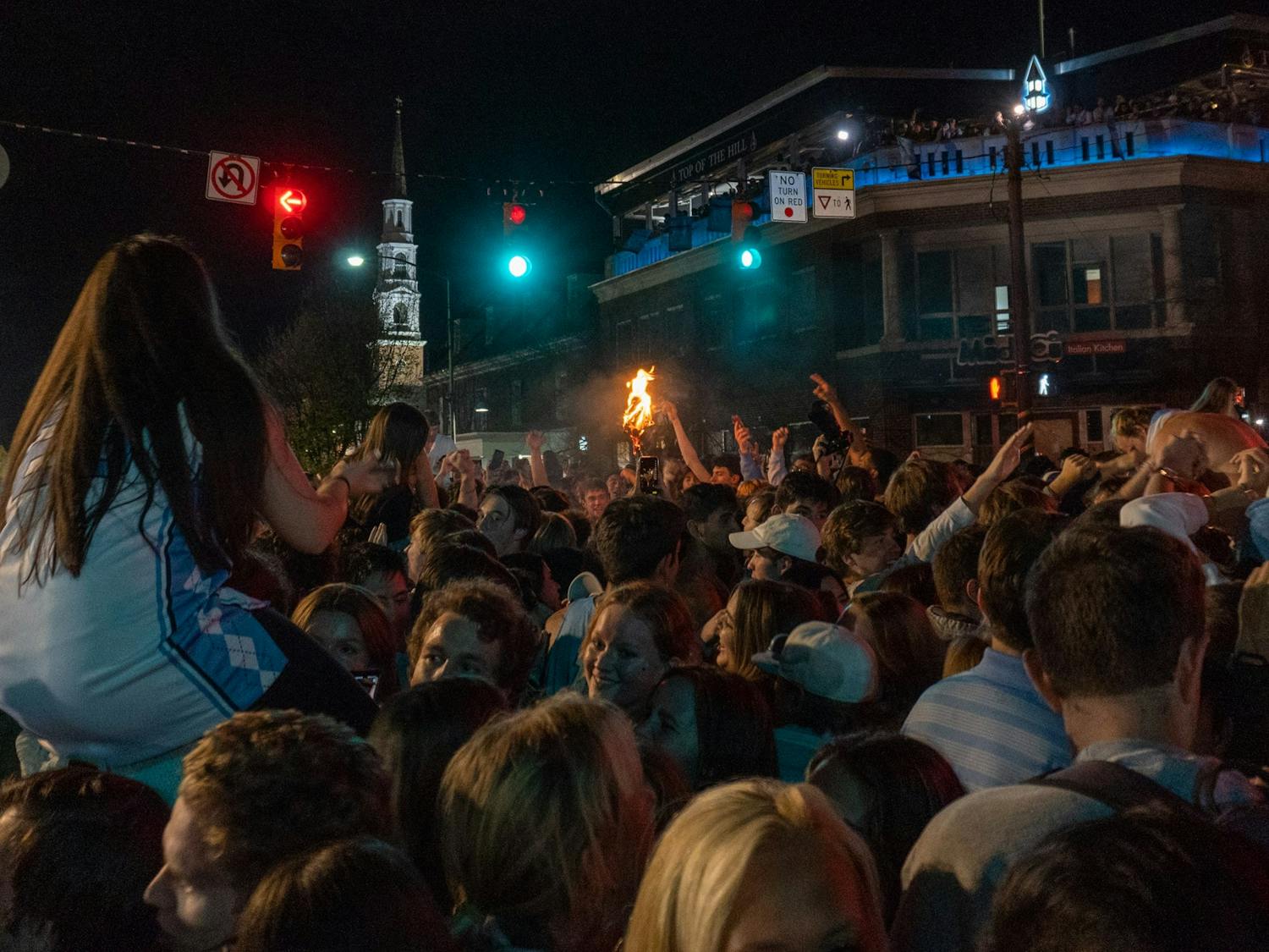 North Carolina men's basketball fans rush Franklin St. after a historic win over Duke in the Final Four game on Saturday, Apr. 2, 2022. UNC won 81-77.