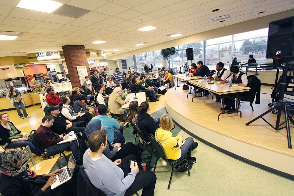 From left to right on the stage table, Phoebe Conybeare, Jacob Speck, Jelani McGadney and Muneeb Kahn, who are all running for student body president, answered questions at the debate Wednesday.