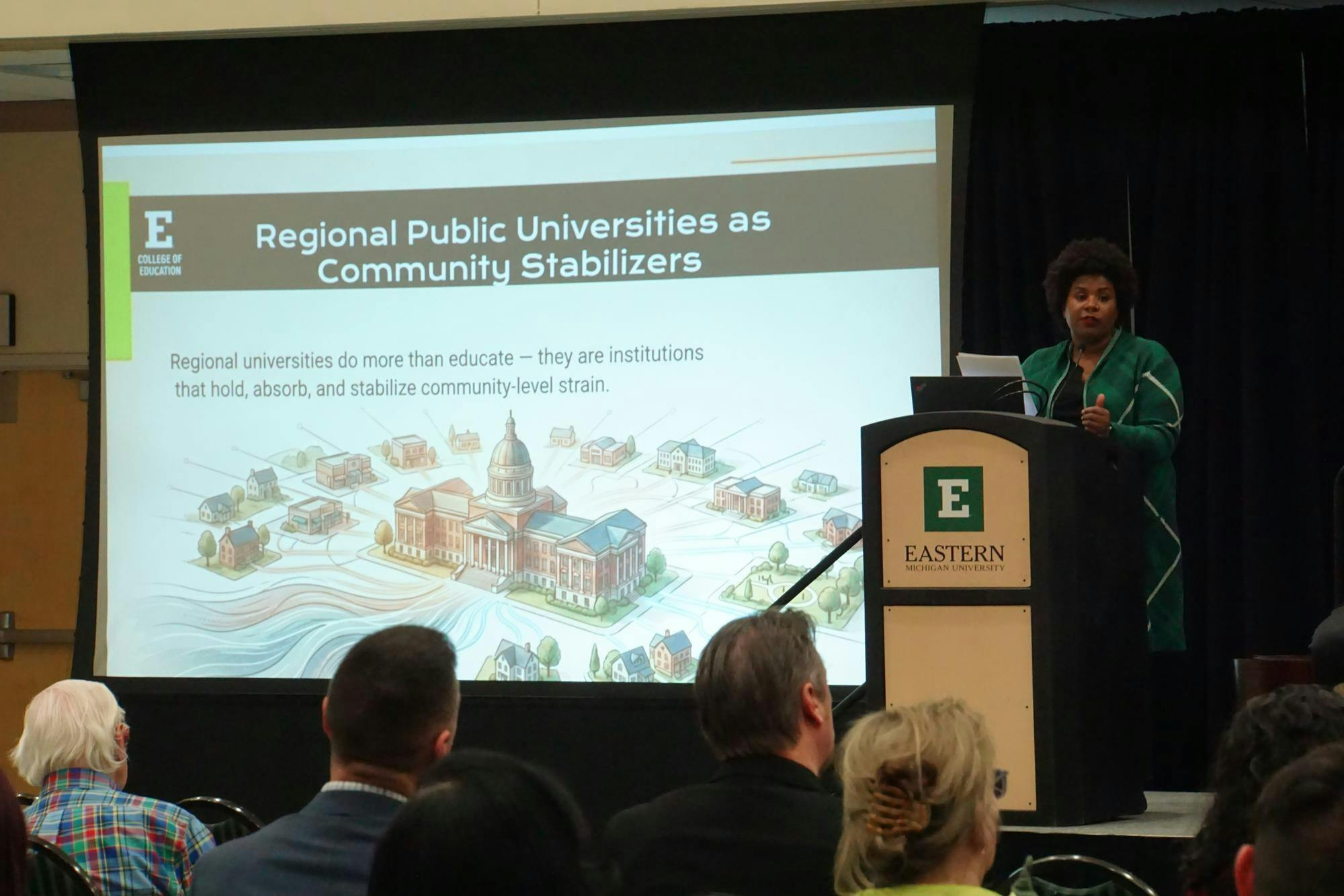 A view of Aesha Mustafa presenting from behind the podium at the EduTalk.
