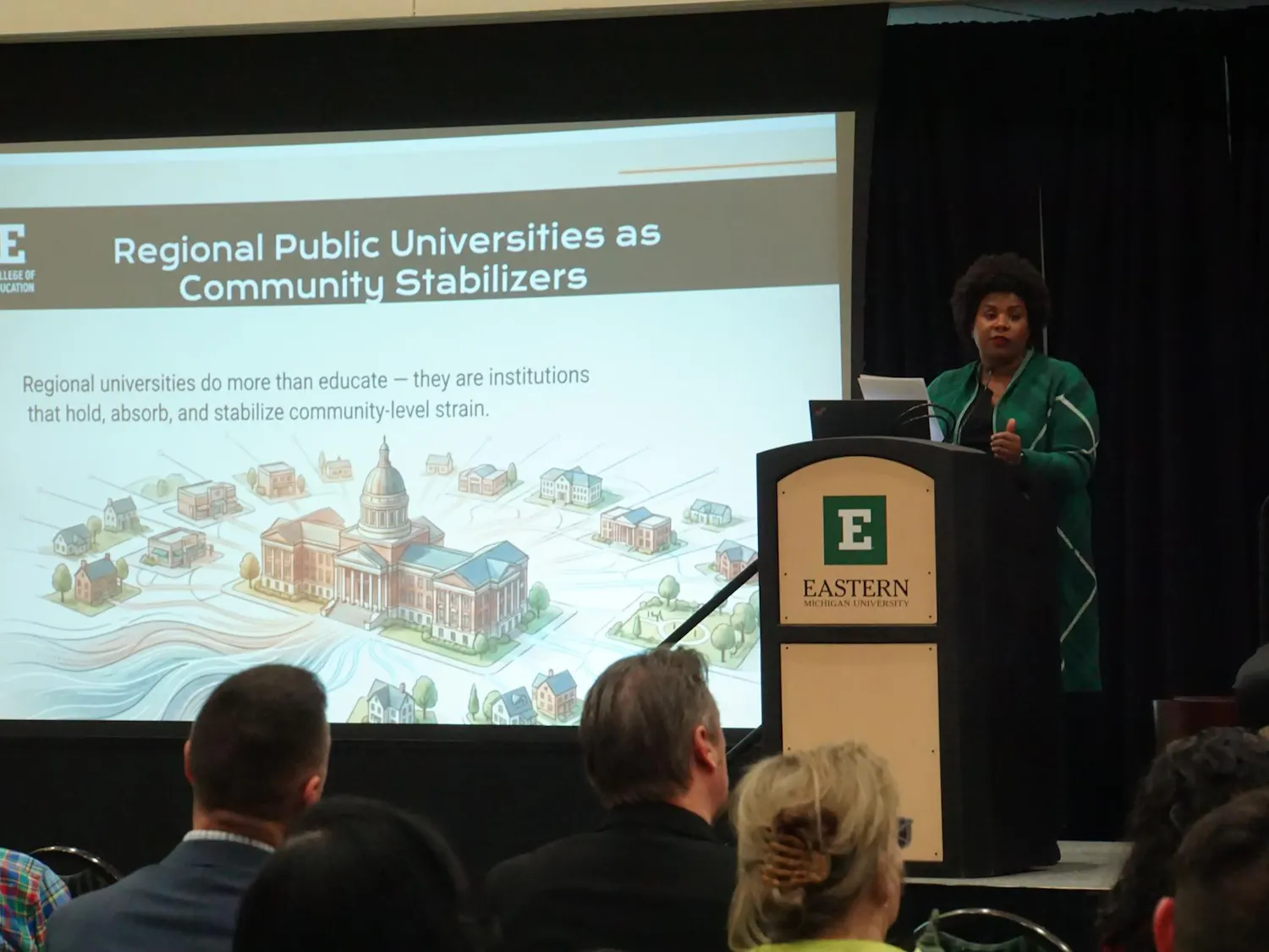 A view of Aesha Mustafa presenting from behind the podium at the EduTalk.