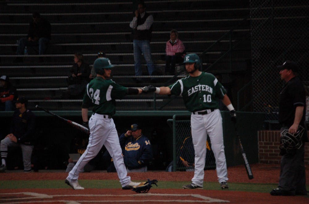 EMU centerfielder Austin Wilson (24) and Lee Longo (10) exchange fist bumps after they both scored runs in the Eagles’ 15-9 win over Siena Heights Thurs. Apr. 10.
