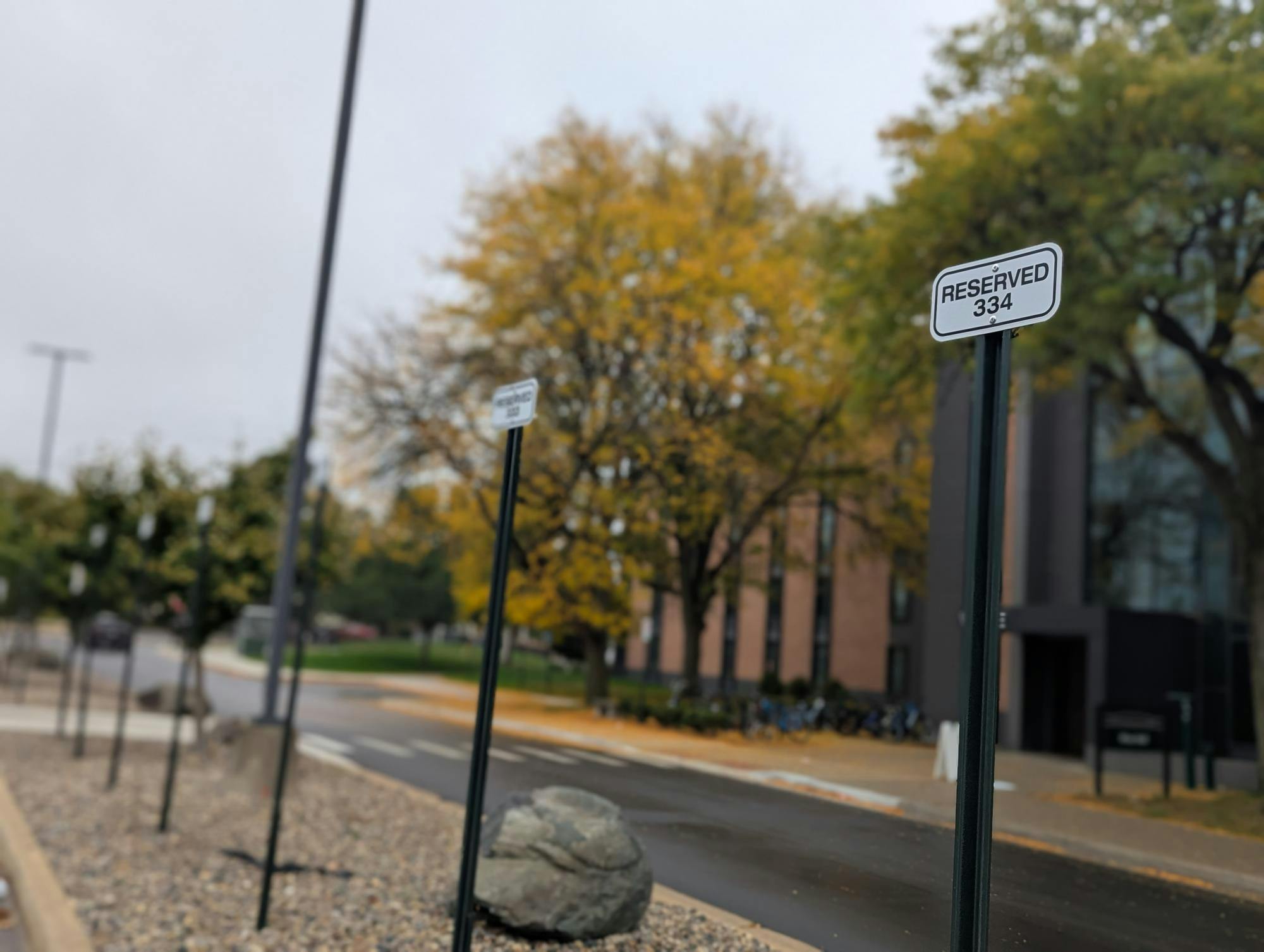 Reserved parking signs line the front of a building.