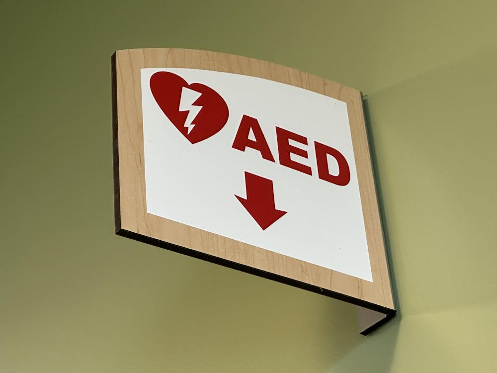 A sign points toward an AED cabinet in Eastern Michigan University's Student Center.