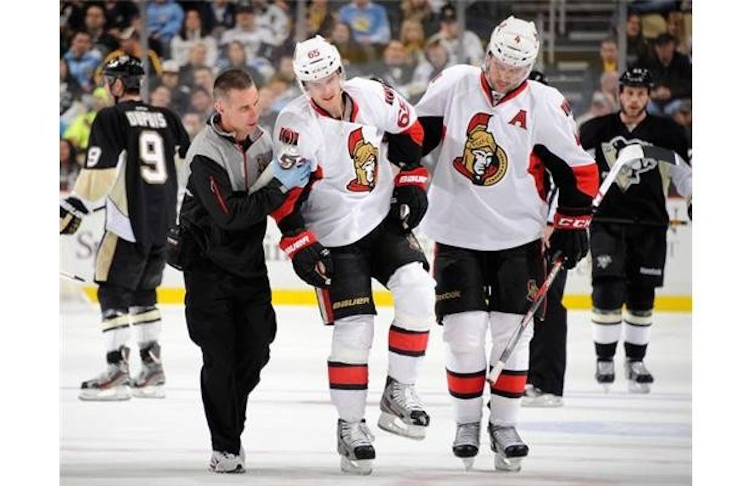 	Ottawa’s Erik Karlsson is helped off the ice by Chris Phillips Feb. 13.
