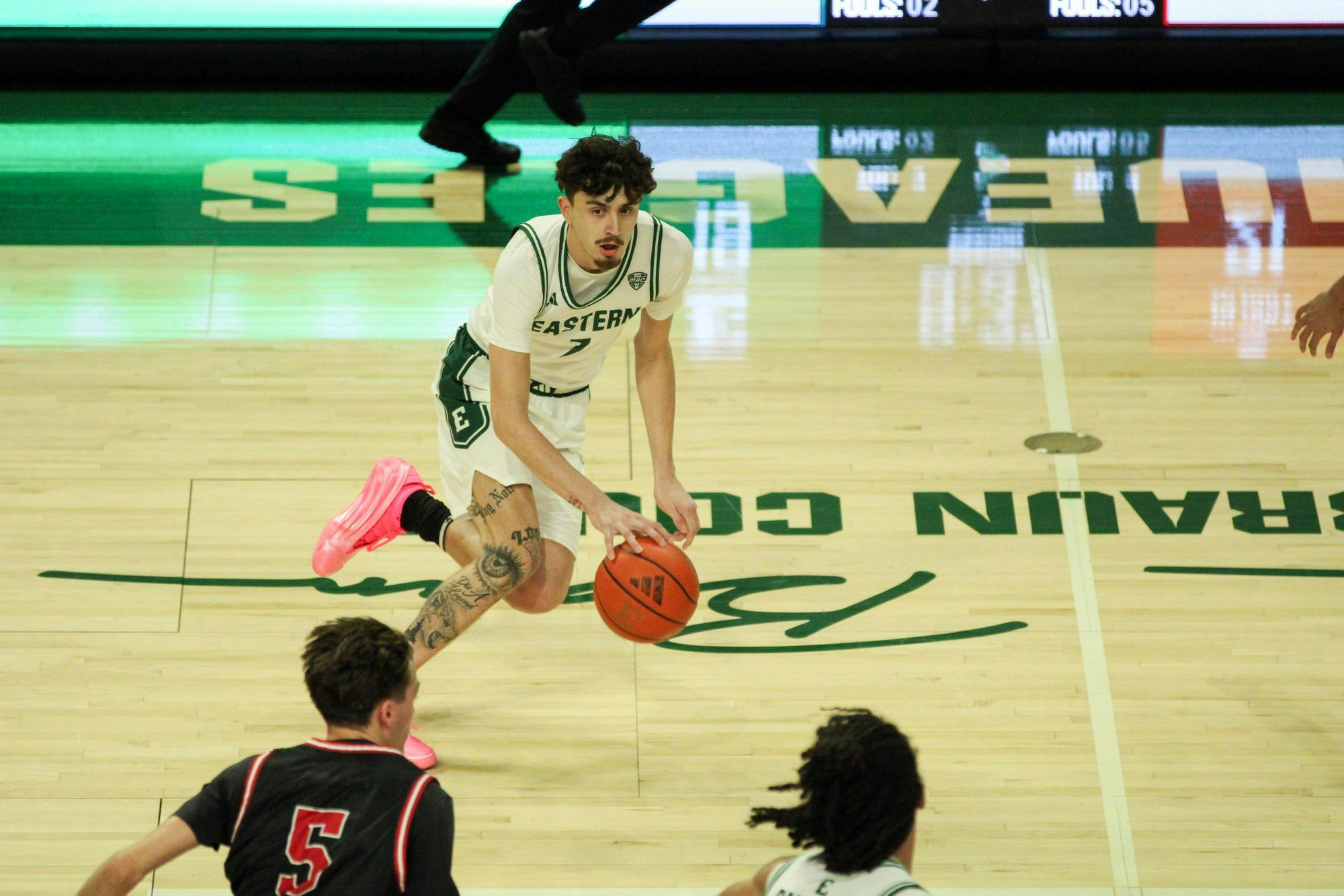 #7, in a white jersey, dribbling the ball