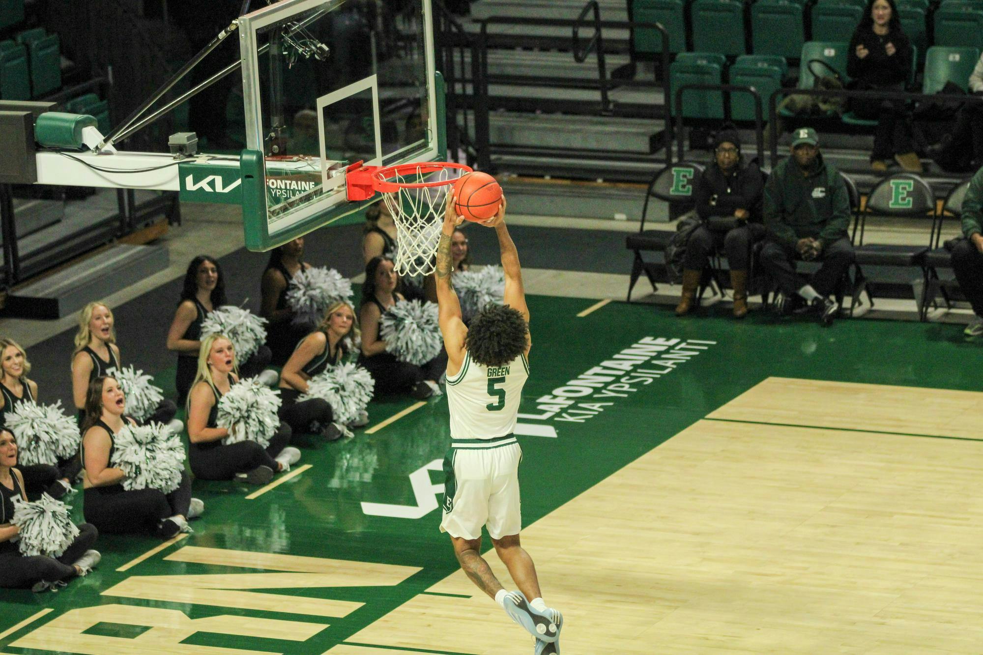 #5 Braelon Green, in a white Eastern Michigan University jersey, dunking the ball. 