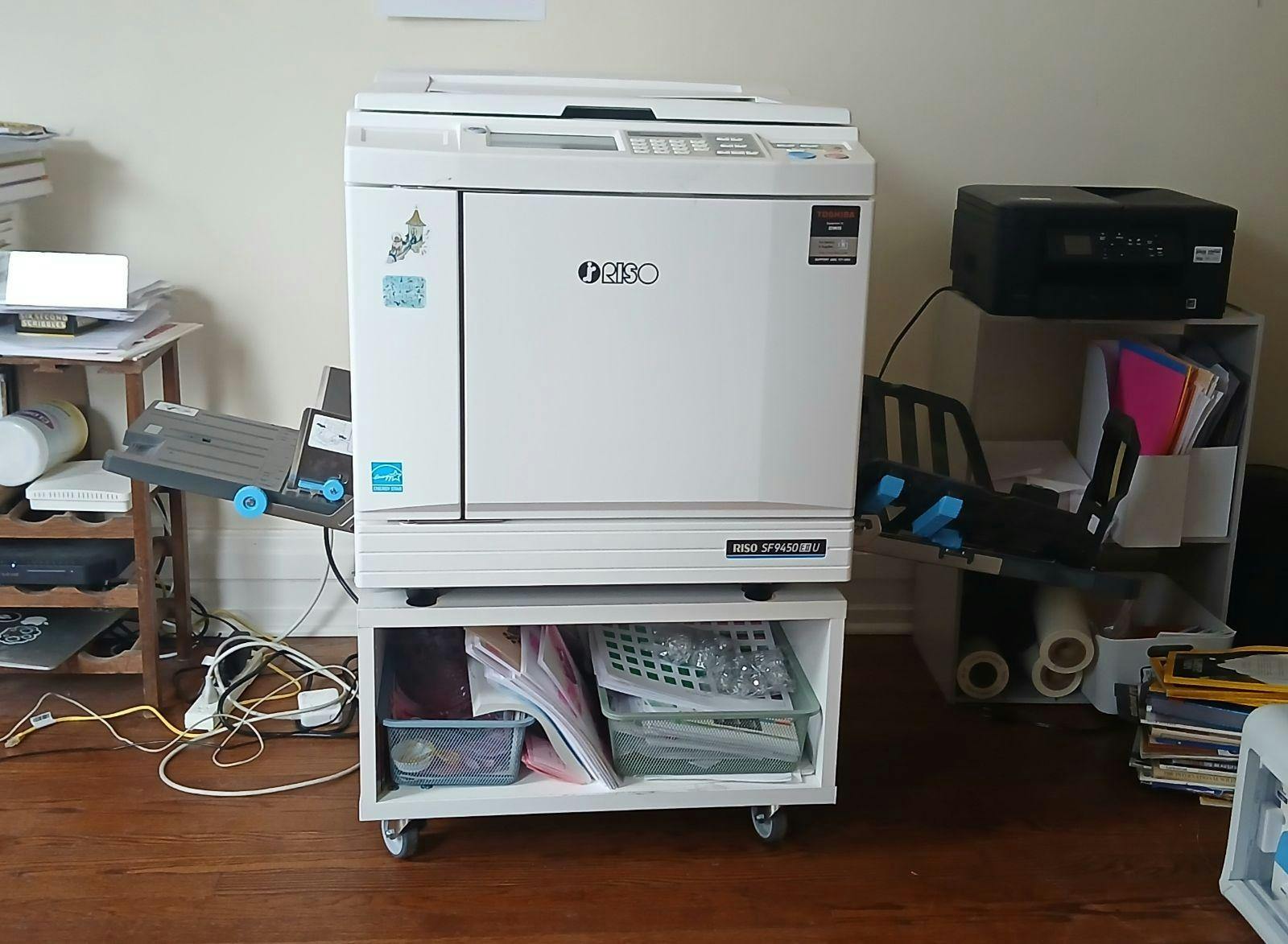 Risograph machine in a room inside Dzanc House. It looks like a tall desktop printer.