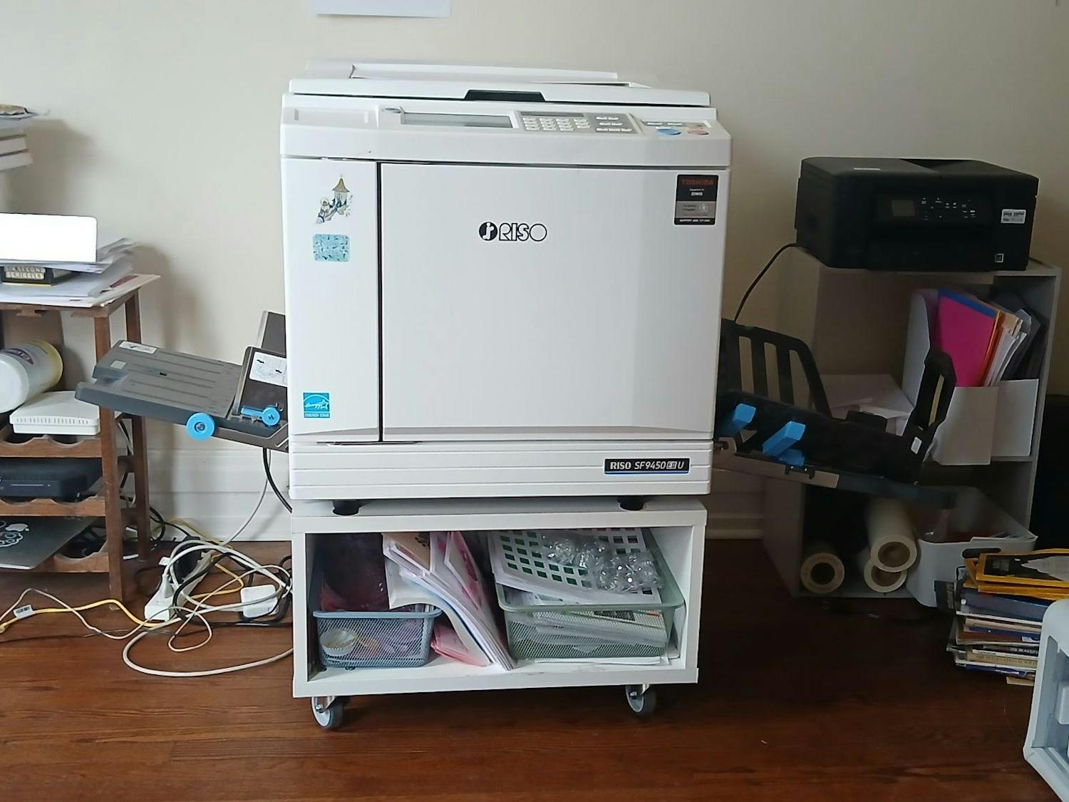 Risograph machine in a room inside Dzanc House. It looks like a tall desktop printer.