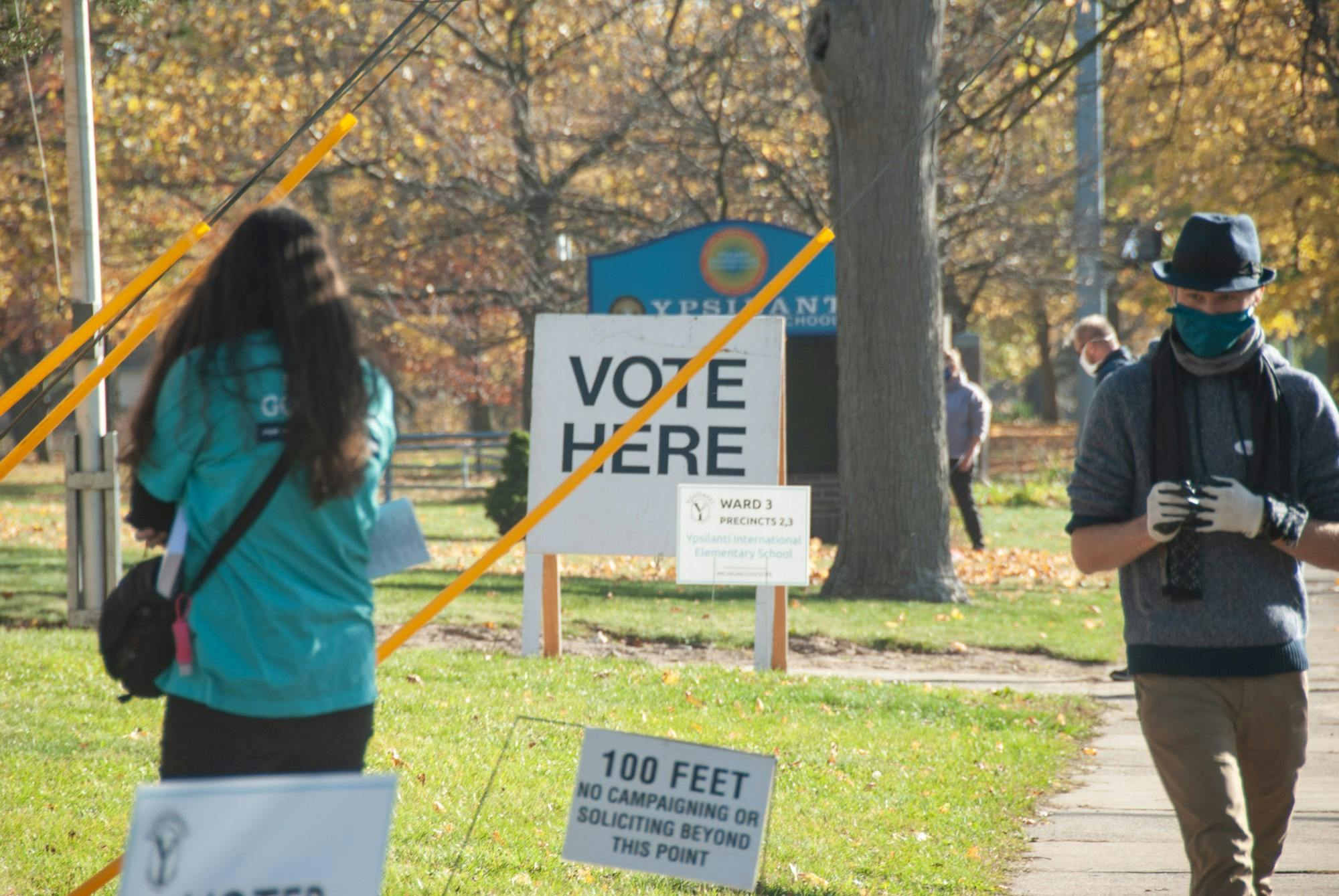 Voters exit a polling place at Ypsilanti International Elementary School