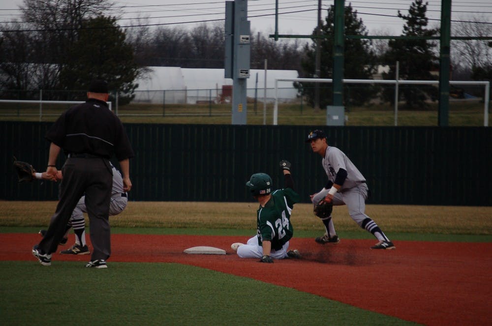 EMU centerfielder Austin Wilson slides into second base with a steal in EMU’s 15-9 win over Siena Heights Thurs. Apr. 10.