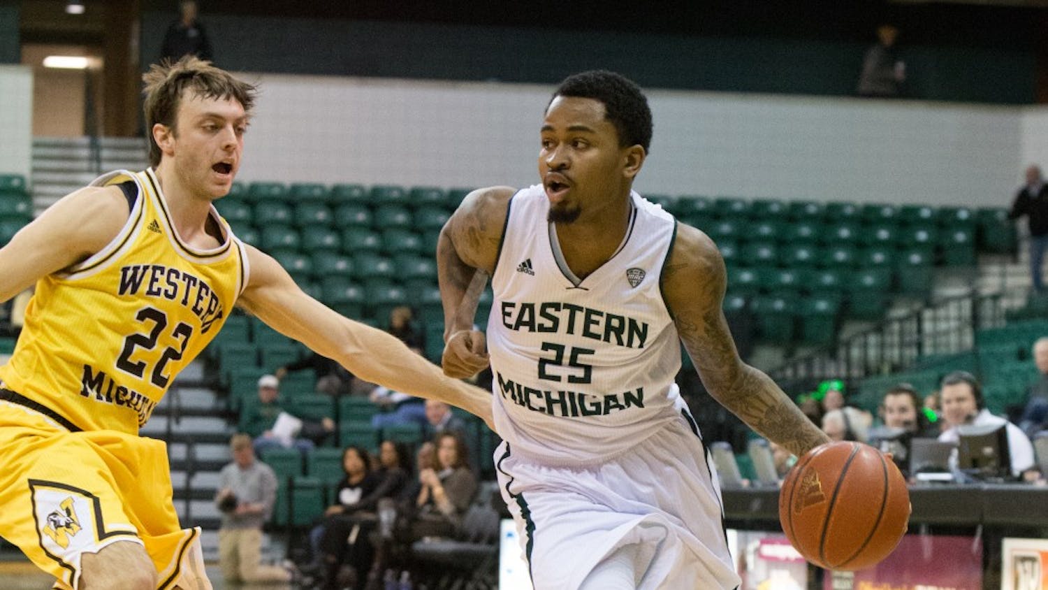 EMU guard Darell Combs (25) drives past WMU's Austin Richie (22) in Eastern Michigan's 56-37 win over Western Michigan Tuesday night. Combs scored 14 of the Eagles points.
