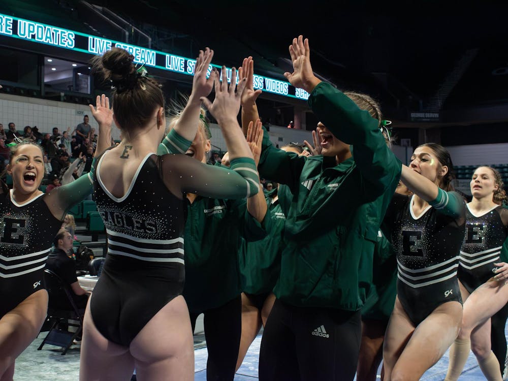 The Gymnastics team celebrates together after a gymnast perfected their event.