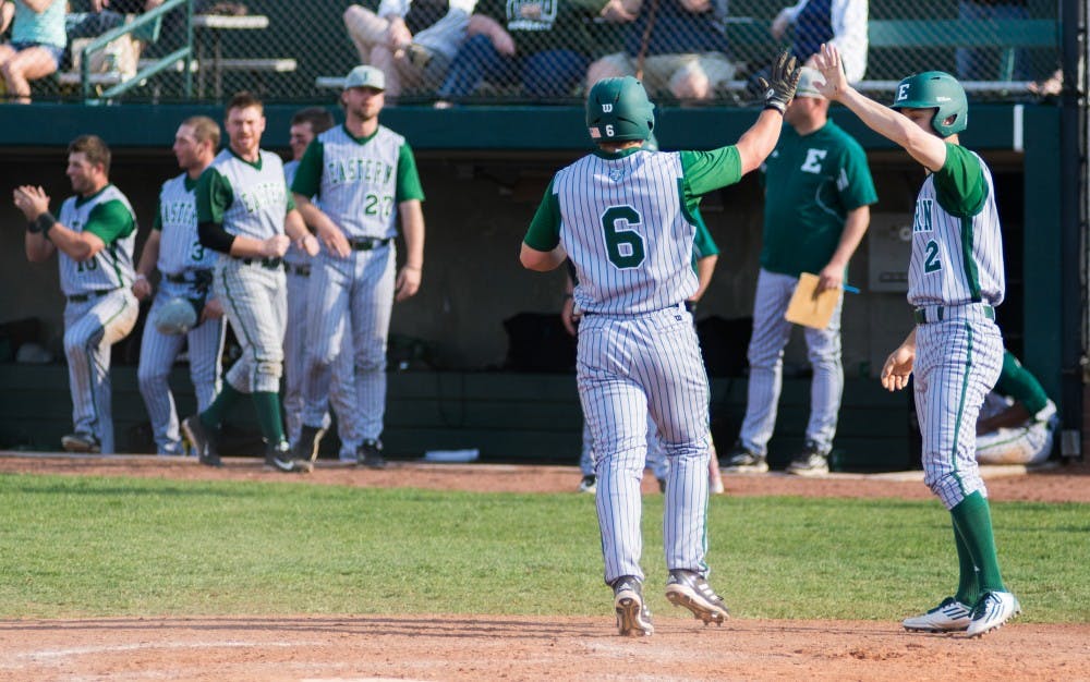 Ty Gilmore and Nick Rotola celebrate their two runs in the ninth inning during the Eastern Michigan vs. Ohio University baseball game at Ohio University in Athens, Ohio on Saturday, April 26, 2014.
