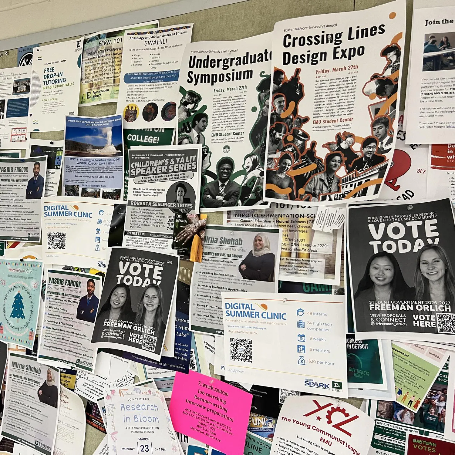 Dozens of flyers, including many campaign flyers, cover a barely visible bulletin board.
