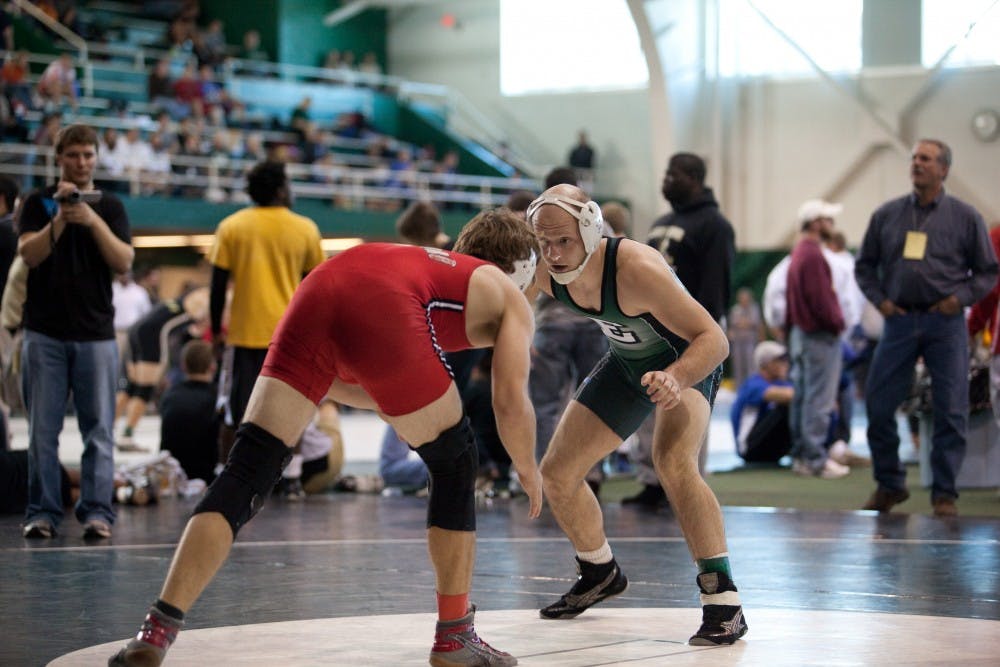 EMU’s Lester France (right) wrestles Dan Snyder of Edinboro (Pa.) in the 157-pound open division.