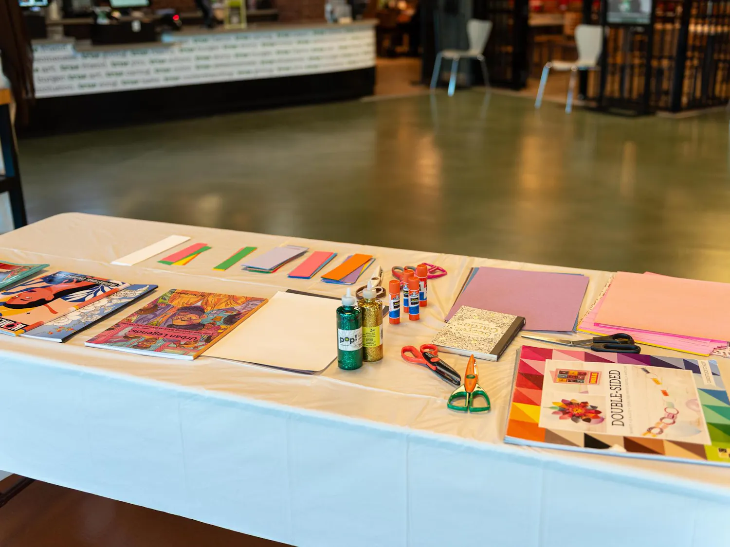 Craft materials are laid out on a table in the Student Center.
