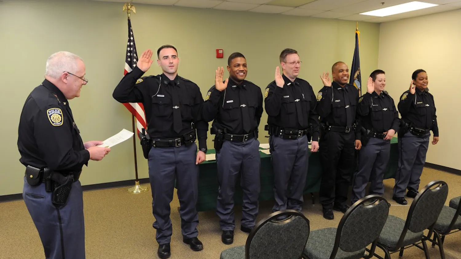 EMU Cheif Heighes swears in 6 new officers.