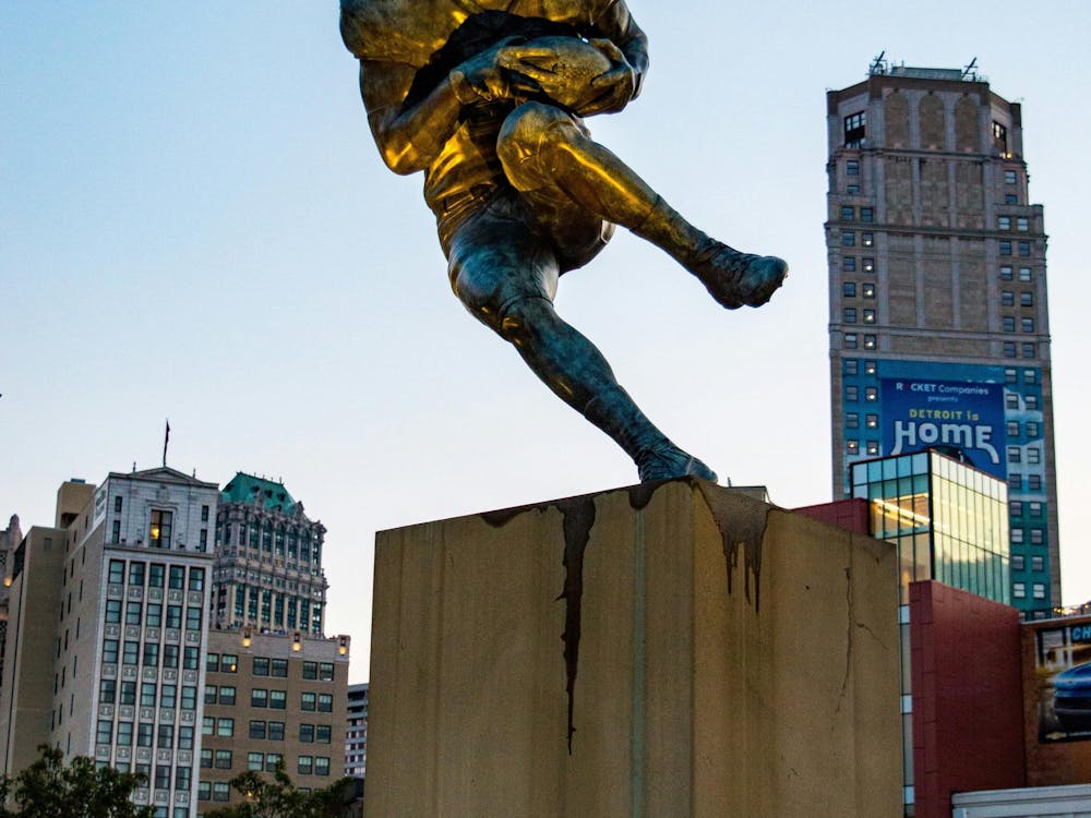 A football statue sitting peacefully inside the city of Detroit.