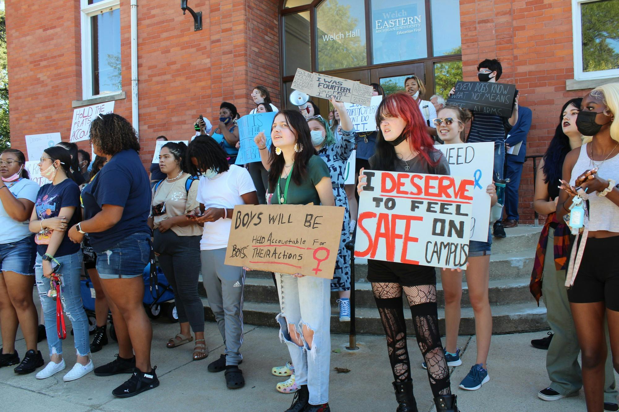 Students carrying signs of protest fill the steps of Welch Hall on the Eastern Michigan University campus in Ypsilanti, Michigan. 