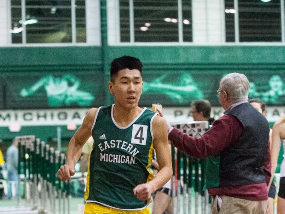 Eastern Michigan distance runner Cameron Trinh pushes through to win the one mile at the EMU Quad Invite on Jan. 9 at Bowen Field house in Ypsilanti.