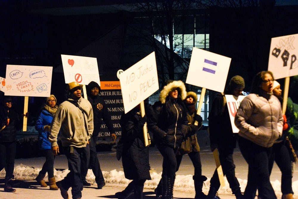 EMU students walk to important historic sites during the Martin Luter King Commemorative March on Jan 15, 2015 on Eastern Michigan University's campus.