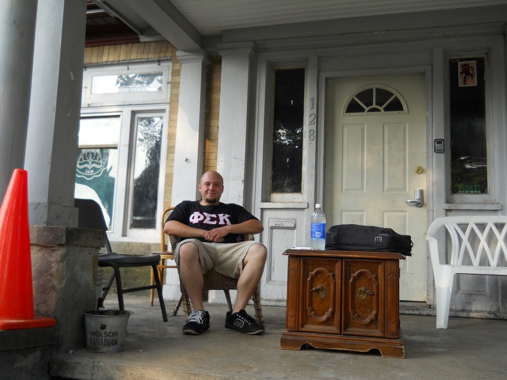  Jeremy Push, a Phi Sig fraternity brother, relaxes on the porch of the Phi Sig House on Normal Street.          
