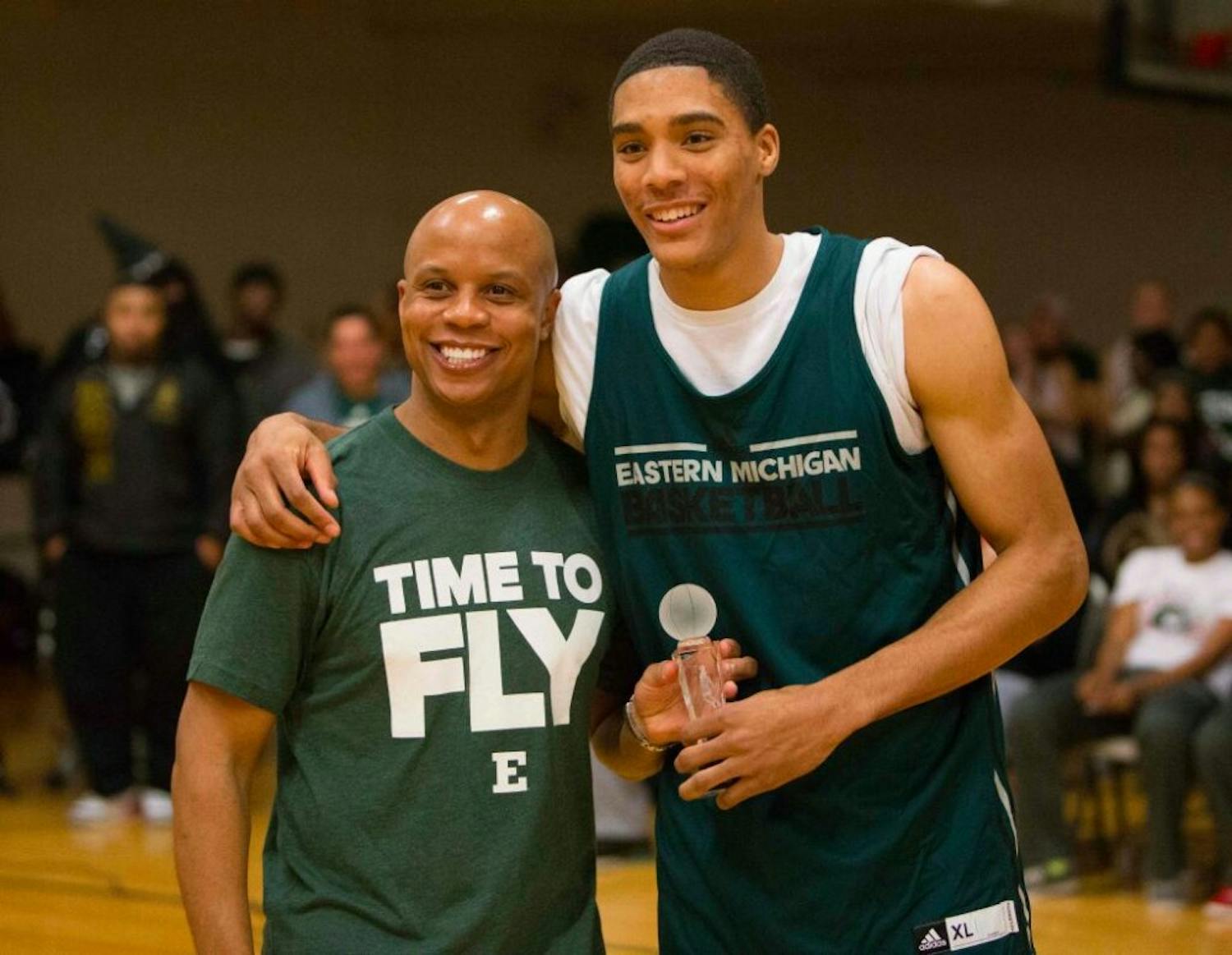 	EMU men&#8217;s basketball coach Rob Murphy (Left) and junior forward Karrington Ward (Right) pose for a photo after Ward won the Demarius Reed Slam Dunk Trophy at Wednesday&#8217;s &#8220;Rock the Rec&#8221; event.