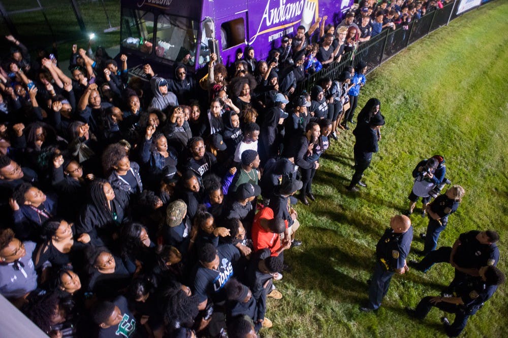 Students of color assemble at EMU football game