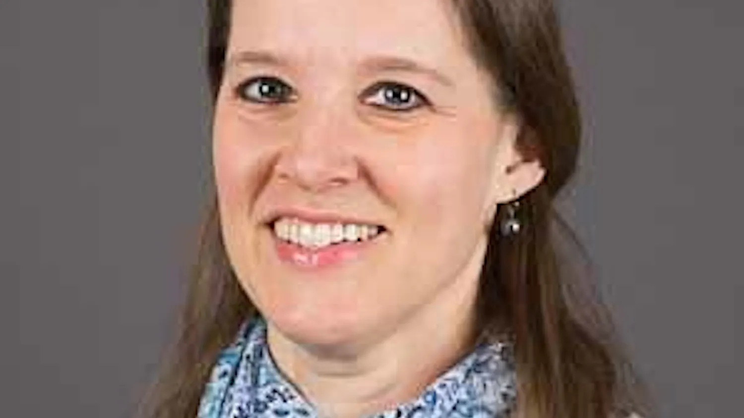 Professional headshot of Jennifer Fisher, shown from the shoulders up.