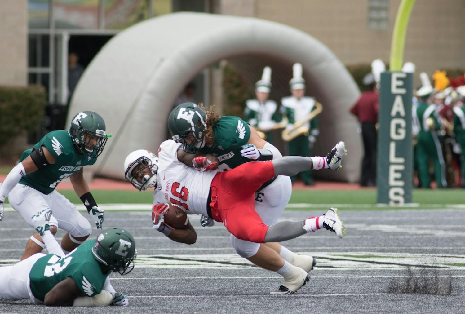 Eastern Michigan defensive lineman Luke MacLean lays down a hard hit on Ball State wide receiver Terin Solomon in the Eagles 28-17 loss to Ball State Saturday afternoon in Ypsilanti, Mich.