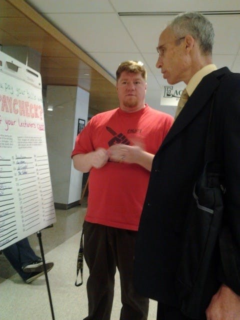 	Zachery Jones explains his position to a passerby. 