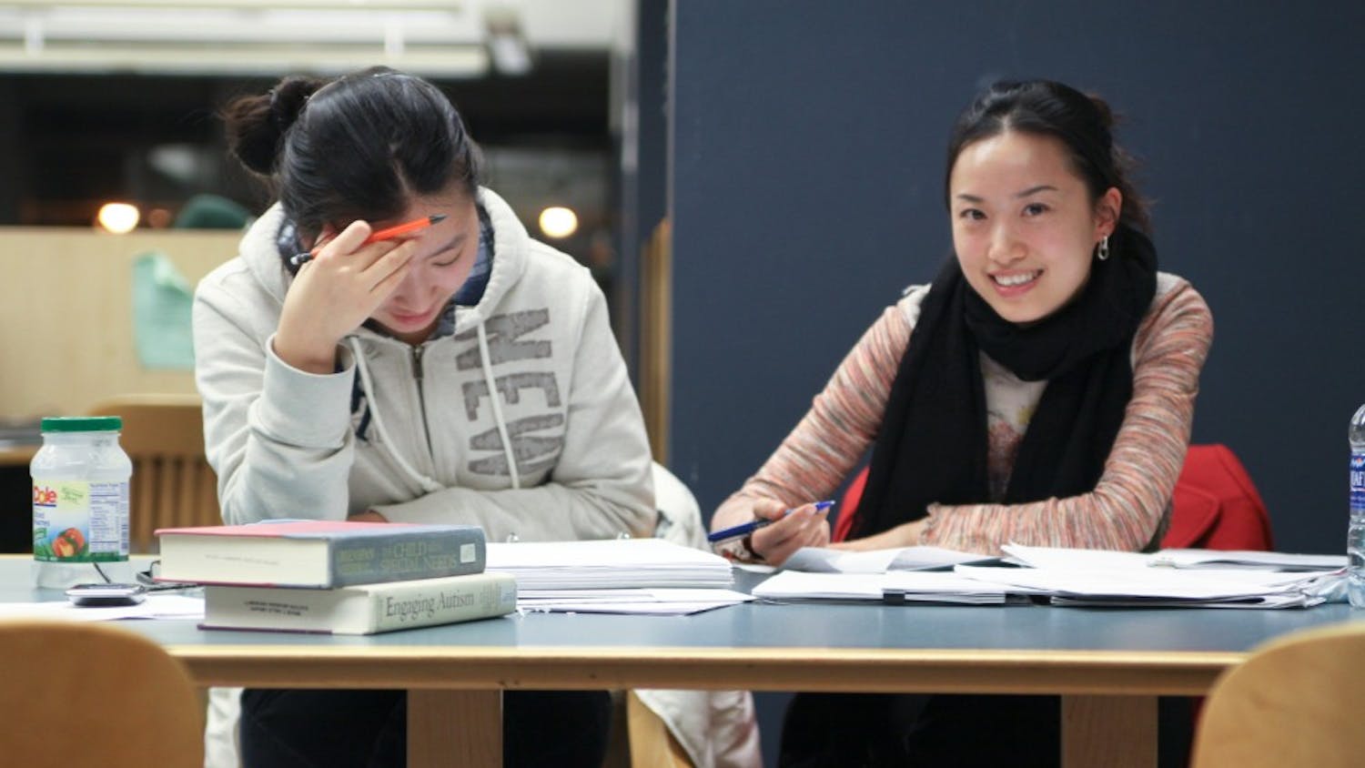 Jingyuan Cao (Left) and Sheila Qin Li get some last-minute studying in before finals week at Halle Library during Club Halle Monday night.