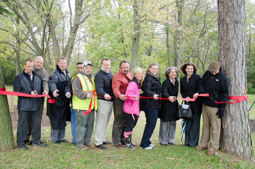 	EMU administrators and staff perform a ribbon cutting for the grand opening of the recreation area just west of Cornell Courts apartements.