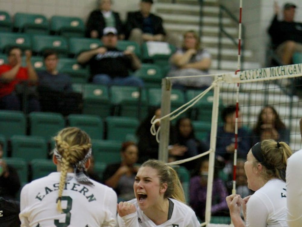 The team celebrates after a kill during the volleyball game against Western Michigan at the Convocation Center in Ypsilanti on Friday, September 30, 2016.