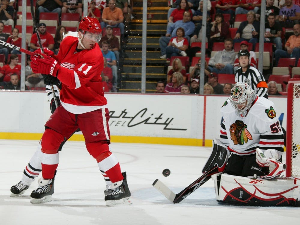 Detroit Red Wings’ Dan Cleary screens Chicago Blackhawks goalie Corey Crawford on this first-period shot during NHL exhibition action at Joe Louis Arena Sept. 24. Critics worry that the health of the team is at risk with 14 players being over the age of 30.