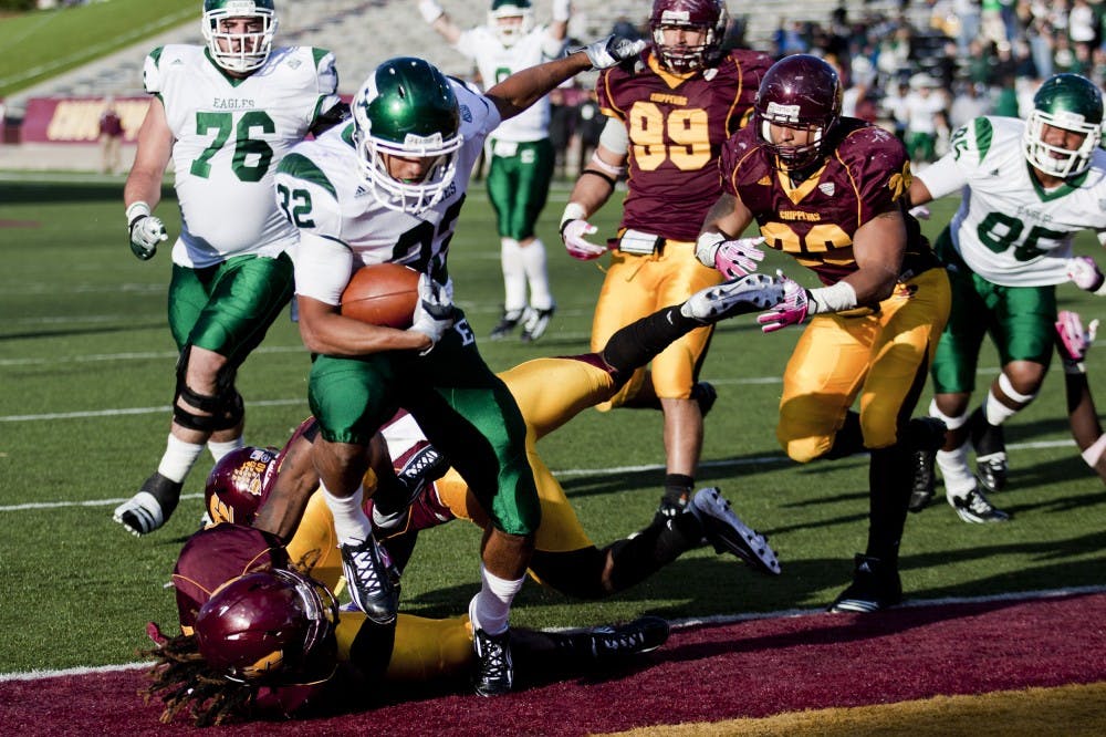 Jeff Smith/Photo EditorSophomore running back Javonti Greene scores during the second half Saturday at Kelly/Shorts Stadium. CMU lost 35-28.