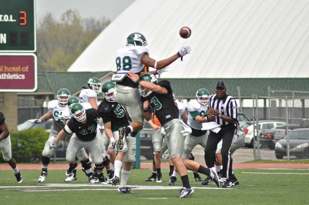 Football plays green and white spring game