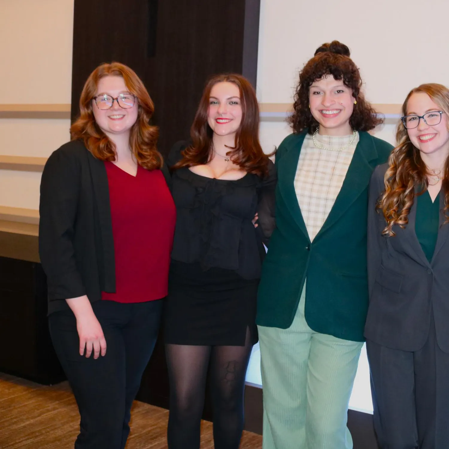 Five students stand and smile at the Michigan Press Association conference.