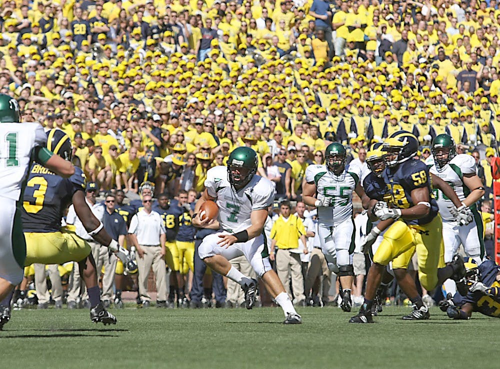 Andy Schmitt (7) runs on Saturday against Michigan.  He later left during the fourth quarter with a season-ending knee injury.