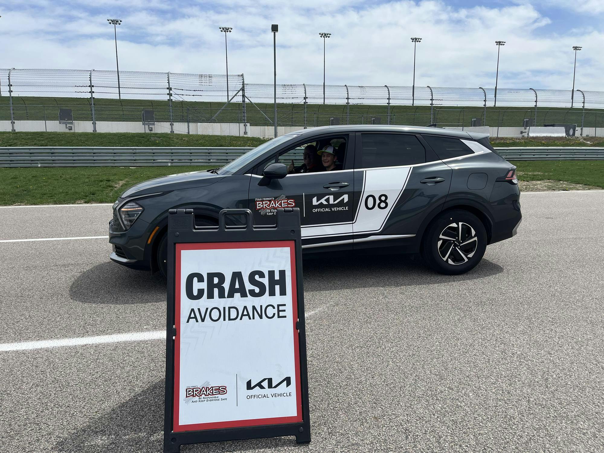 A training vehicle behind a sign that says "crash avoidance."