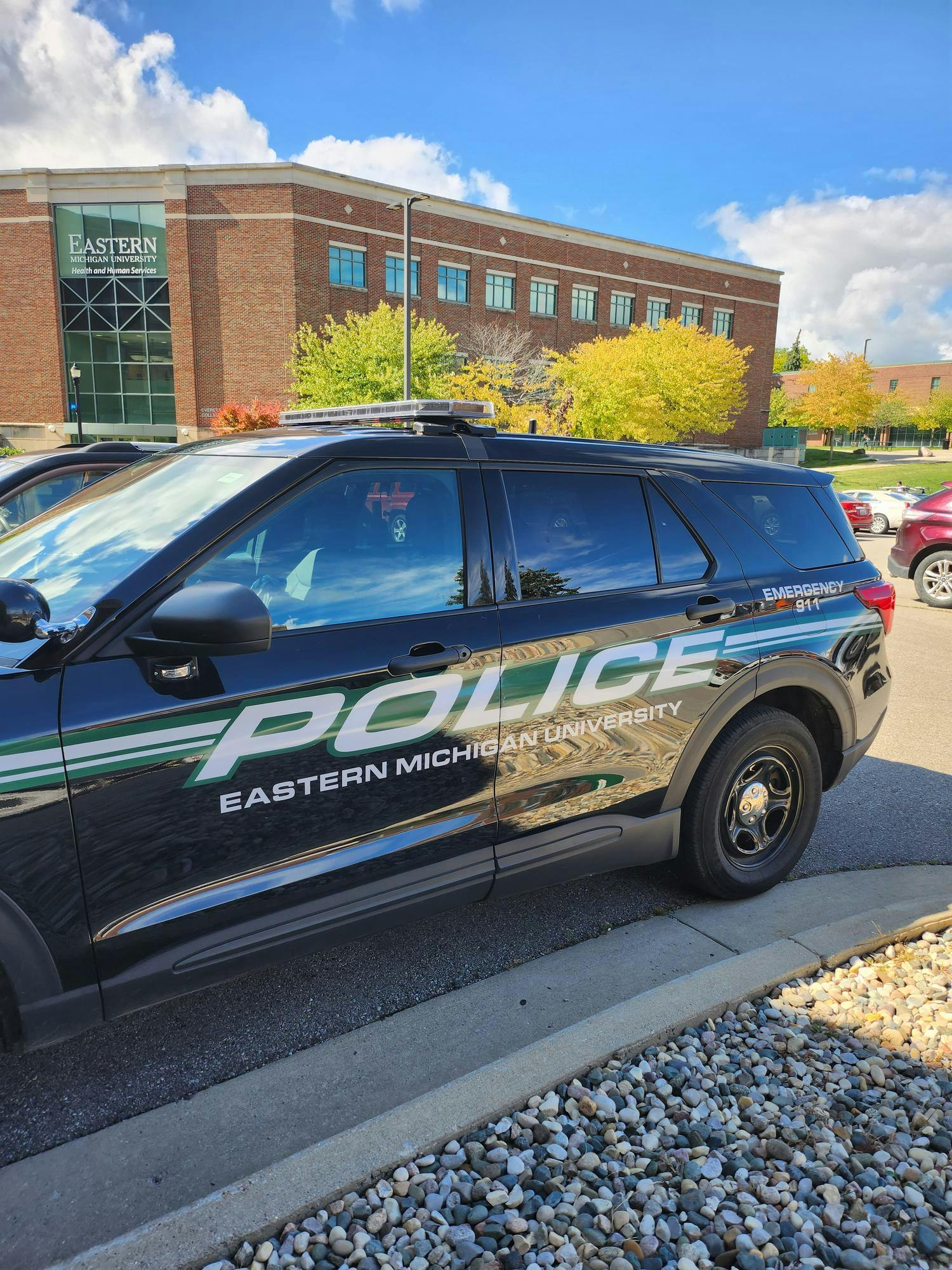 A police-labeled vehicle used by the Eastern Michigan University Department of Public Safety is parked on campus.