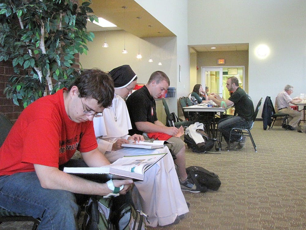 (Closest) From left to right, EMU students David Zagorowski, a junior, Sister Catherine Marie Compton, senior, and Blaine Kuneman, a grad student wait to give blood at last Monday's blood drive.