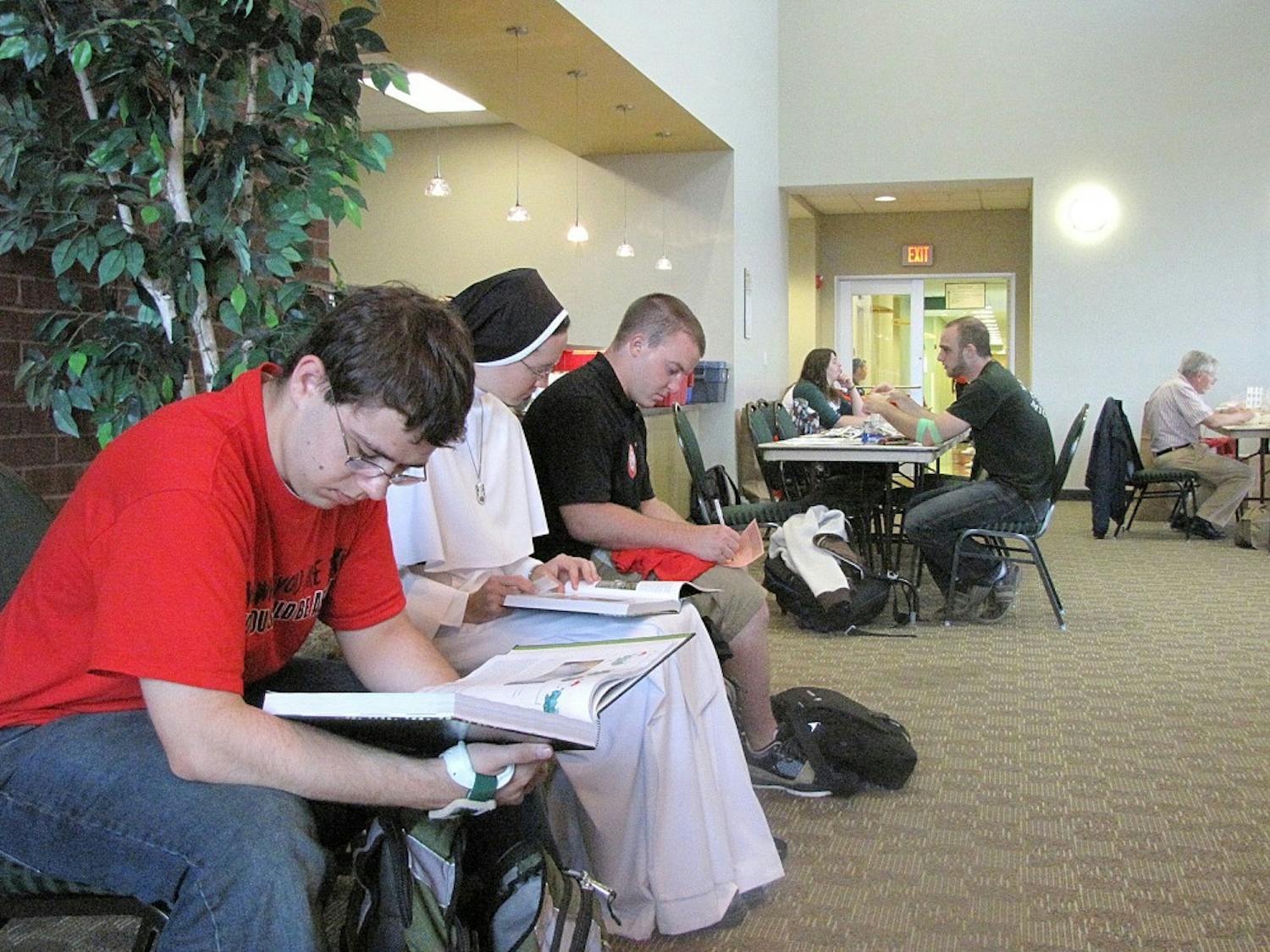 (Closest) From left to right, EMU students David Zagorowski, a junior, Sister Catherine Marie Compton, senior, and Blaine Kuneman, a grad student wait to give blood at last Monday's blood drive.