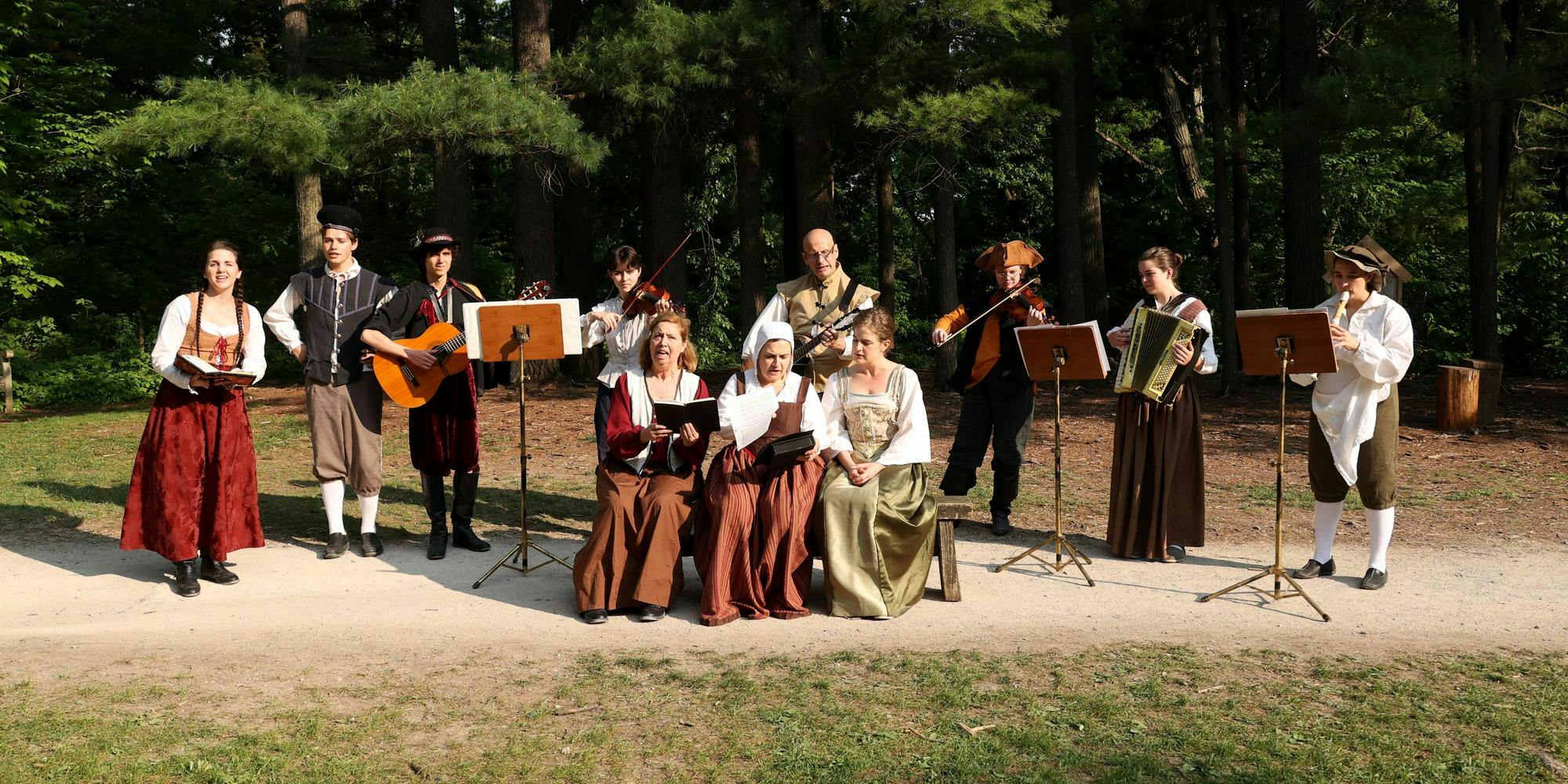 Ten musicians dressed in Shakespearean attire performing in Nichols Arboretum. 