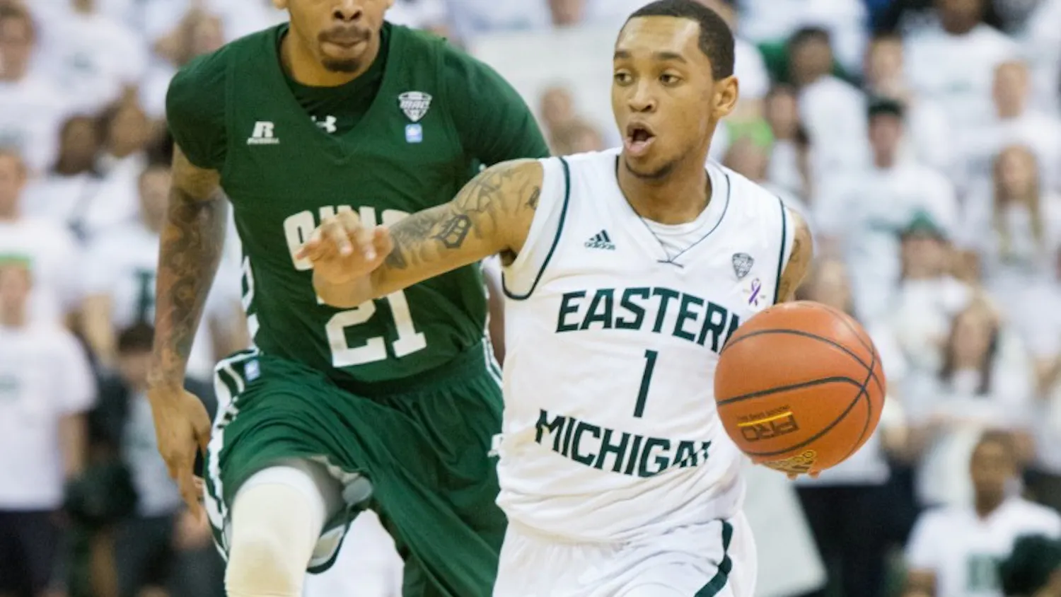 EMU guard Mike Talley drives past Ohio forward John Smith (21) in Eastern Michigan's 58-56 loss to Ohio Saturday.