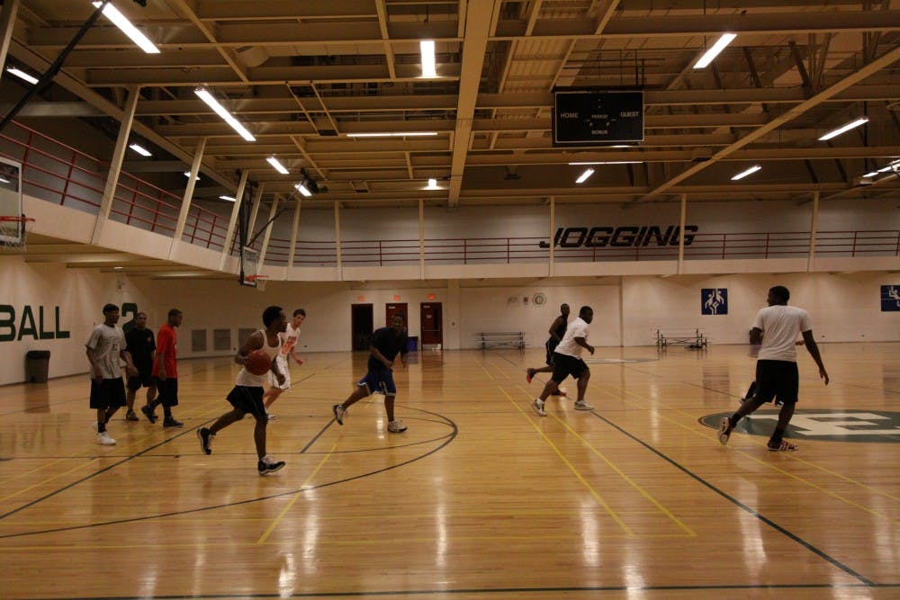 A group of Eastern Michigan University students heads to the Rec/IM for a game of basketball.