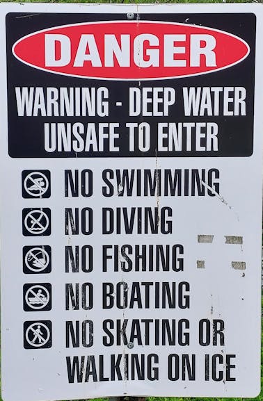 A photo of a sign with black bold text on a white background shows a list of forbidden actions at the EMU's ponds.
