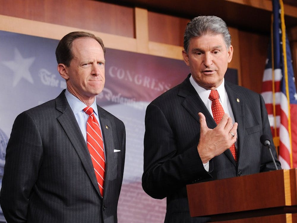 Sens. Joe Manchin III (D-WVA) speaks as Patrick J. Toomey (R-PA) looks on during a press conference to announce a bipartisan deal on background checks for gun shows and Internet sales at the Capitol April 10, 2013 in Washington, D.C. (Olivier Douliery/Abaca Press/MCT)