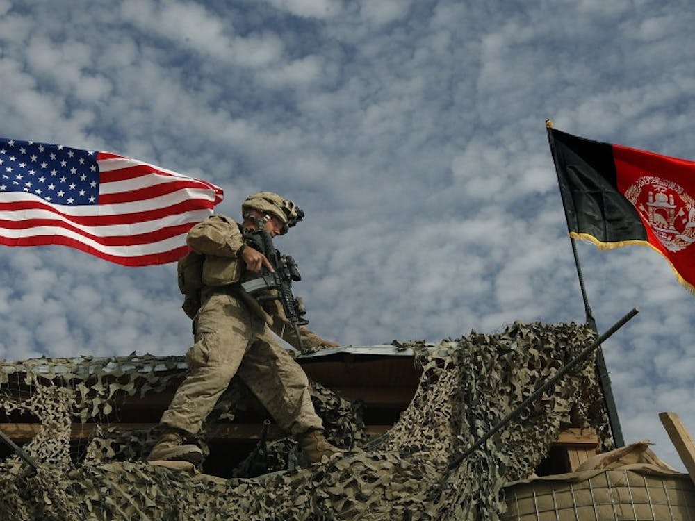 LCpl John Westwood, of Pittsburgh, Pennsylvania, negotiates the narrow ledge of a guard tower after putting the finishing touches on the U.S. and Afghanistan flags he erected at the main gate of FOB Hassanabad which Golf Company of the 2/2 calls home in the Helmand Province of Afghanistan, December 1, 2009. He said after erecting the flag, "I was putting up the American flag and the Afghan flag and I felt all the honor in the world to be able to do something like that- to put up our flag in a foreign country I think was a great deal. When I was finished putting those flags up... the words couldn't... can't express the way it made me feel." (Chuck Liddy/Raleigh News & Observer/MCT)