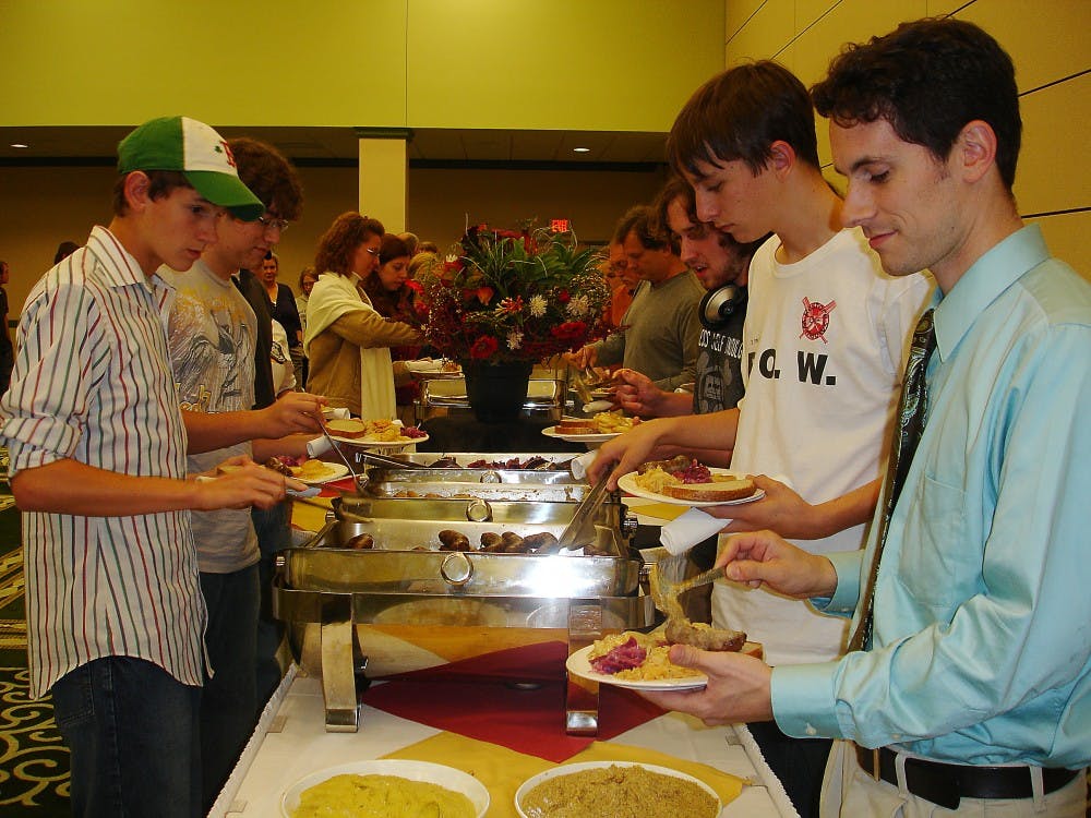 	EMU alumni and current high school teacher David Baldwin (right) stands in line for food with his students at last year’s German-American Day.